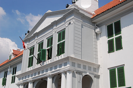 white concrete building with flag thumbnail