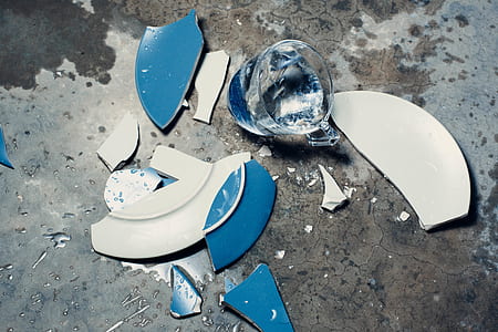 broken blue and white ceramic plate on grey surface thumbnail