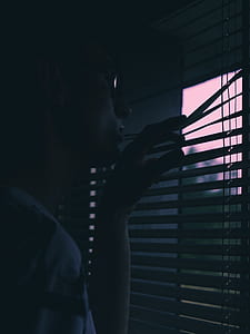 person peaking through window blinds thumbnail