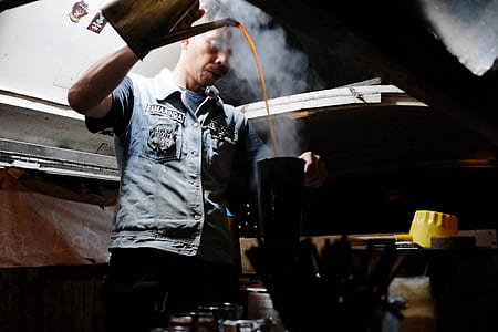 man holding a teapot pouring a cup thumbnail