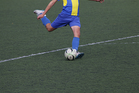 soccer player trying to kick the ball thumbnail