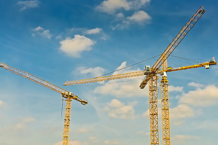 photo of yellow tower crane at daytime thumbnail