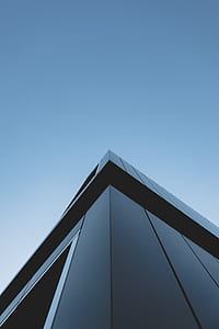 shallow focus photography of gray concrete building under blue sky thumbnail