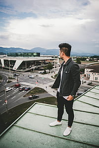 man standing on rooftop thumbnail