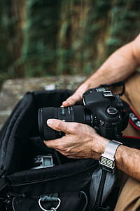 Photographer holding a DSLR camera thumbnail