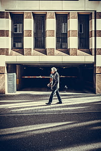 man walking beside parking lot thumbnail
