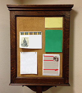 five papers pinned on corkboard with brown wooden frame thumbnail