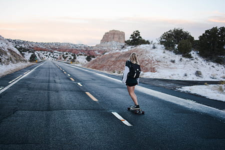 woman ride-on skateboard on concrete road thumbnail