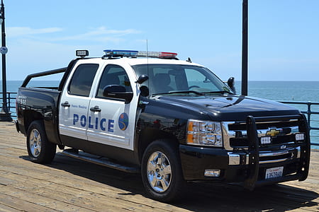 black and white Chevrolet Silverado crew cab pickup truck near body of water thumbnail