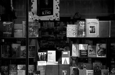 grayscale photography of displayed books in store thumbnail
