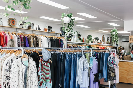 assorted apparel hanged on rack inside room thumbnail