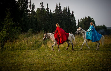 two woman riding on white horses thumbnail