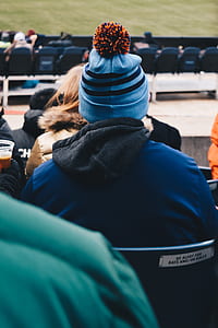person sitting on stadium chair during day thumbnail