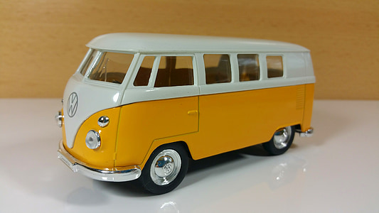 yellow and white Volkswagen Transporter 2 scale model toy on white surface thumbnail