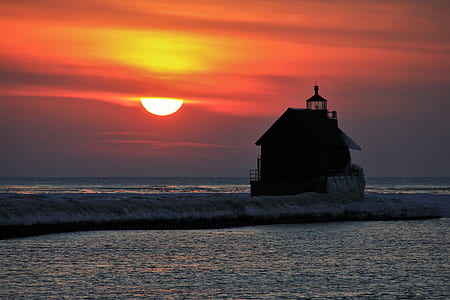silhoutte of house between body of water thumbnail
