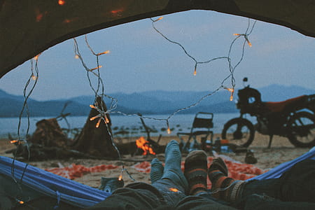 two persons on tent with string lights thumbnail