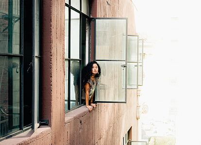 woman looking out the window during daytime thumbnail