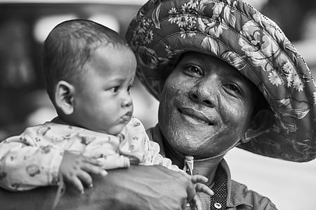 selective focus photography of man holding baby grayscale thumbnail