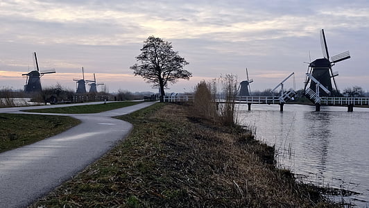 windmill beside body of water thumbnail