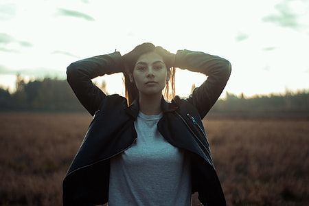 woman standing on grass field taking a photo thumbnail