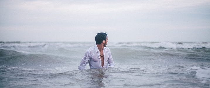 man in sea with waves on back thumbnail