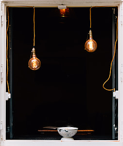 two turned on halogen light bulbs above white bowl thumbnail