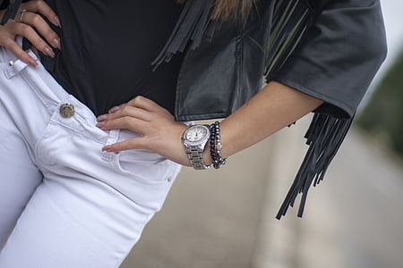 woman wearing fringed black leather jacket and white pants thumbnail