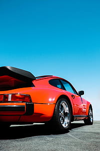 closeup photo of classic red Porsche 911 during daytime thumbnail