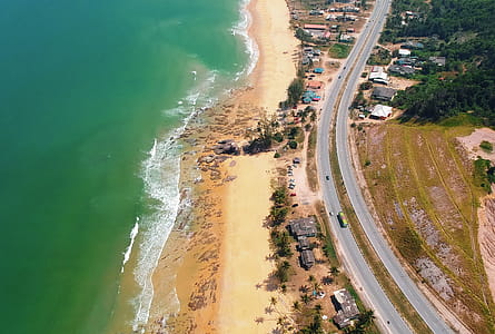 Aerial Photography of Brown Sand Beach Near Road thumbnail