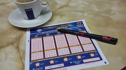 pink and black pen on lotto ticket thumbnail