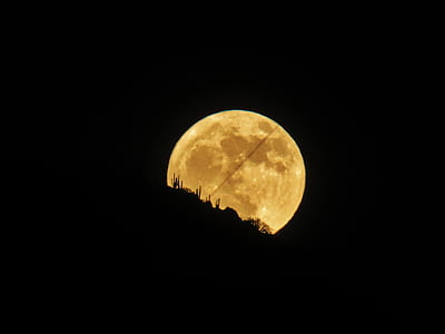 full moon behind hill thumbnail