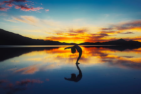 silhouette of a person on body of water thumbnail