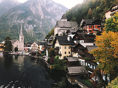 assorted-color houses beside body of water thumbnail