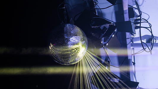 yellow light reflecting on silver-colored disco ball thumbnail