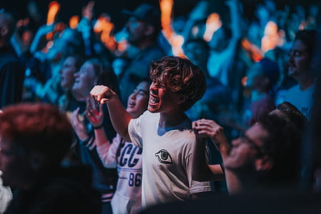 selective focus photography of man wearing white crew-neck t-shirt thumbnail