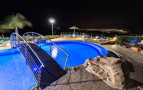 gray bridge over swimming pool during nighttime thumbnail