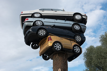 stack of four cars on brown wooden trunk thumbnail