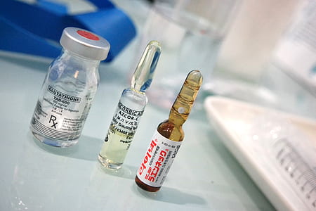three glass bottles on gray surface thumbnail