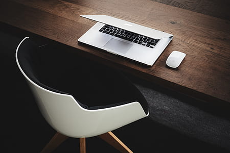 gray MacBook on brown wooden table thumbnail