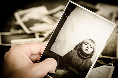 person holding greyscale photo of child thumbnail