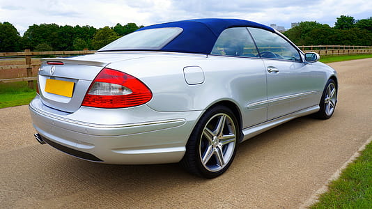 silver Mercedes-Benz convertible coupe on gray concrete road thumbnail