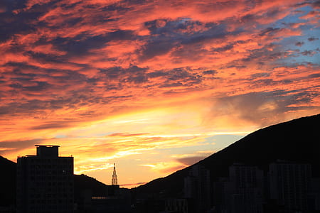 Silhouette Cityscape Against Dramatic Sky during Sunset thumbnail