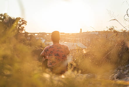 man sitting outdoor during daytime thumbnail