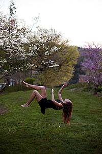 woman in black crew-neck tank dress near the white sakura tree edited photo thumbnail