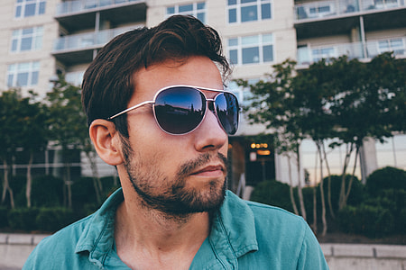 man wearing teal collared shirt and sunglasses thumbnail