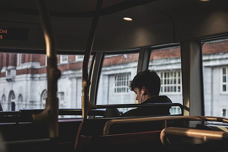 man sitting in bus during daytime thumbnail
