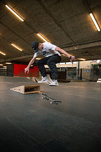 man in white t-shirt doing skateboard tricks thumbnail