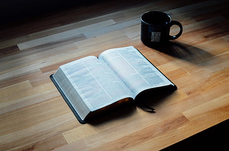 book beside black ceramic mug thumbnail