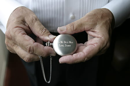 Person Holding Silver-colored Pocket Watch thumbnail