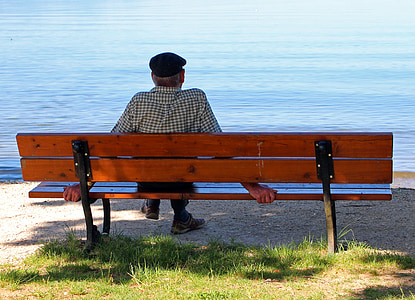 person sitting on brown wooden bench thumbnail